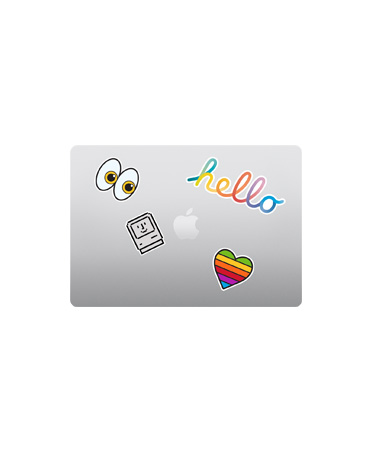 合上的銀色 MacBook Air 機身俯視圖，Apple 標誌四周貼著色彩繽紛的貼紙